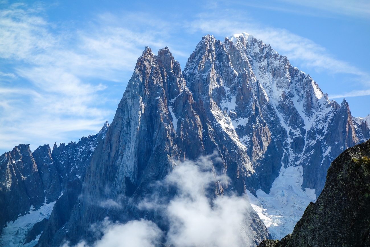 summer alpine rock climbing on the aiguille de l'm chamonix view to les drus and aiguille verte