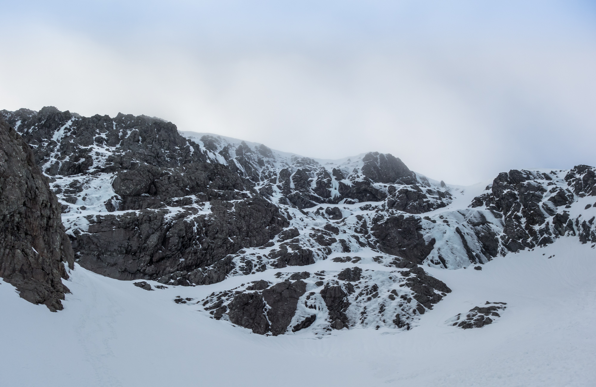 The Gutter and The White Line are the two prominent ice lines on the left of the image on Goodeve's Buttress. A very icy Raeburn's Wall to the right.