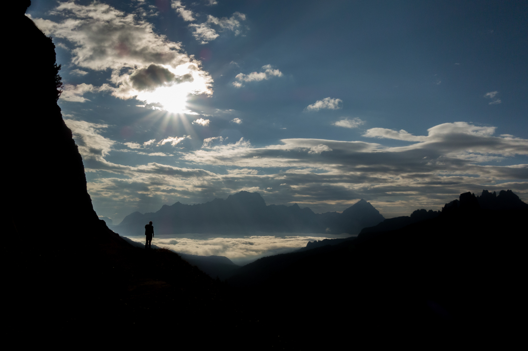 Surreal silhouetted scenes on the approach to the Dibona on Falzarego Grande, while Cortina hides beneath the clouds below