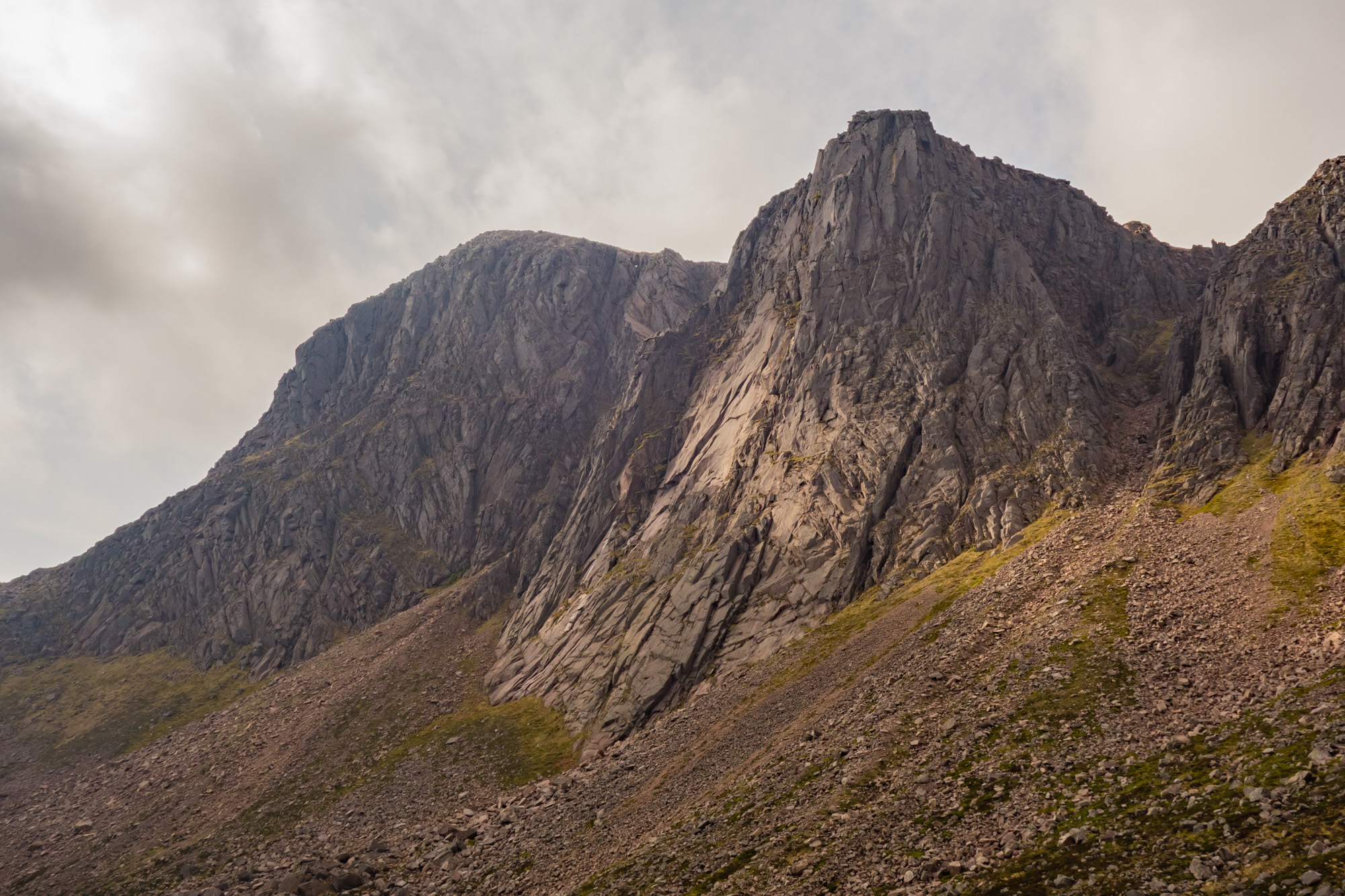 The giant sweep of the Shelterstone Crag with the Central Slabs highlighted by sun beams 