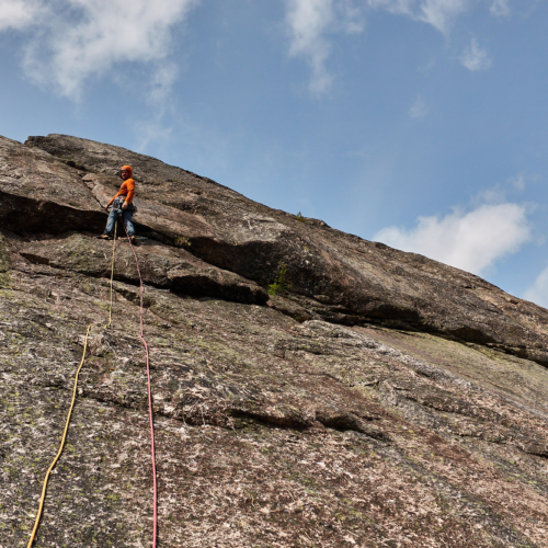 A climber on the fourth pitch of the rock climb called Agent Orange