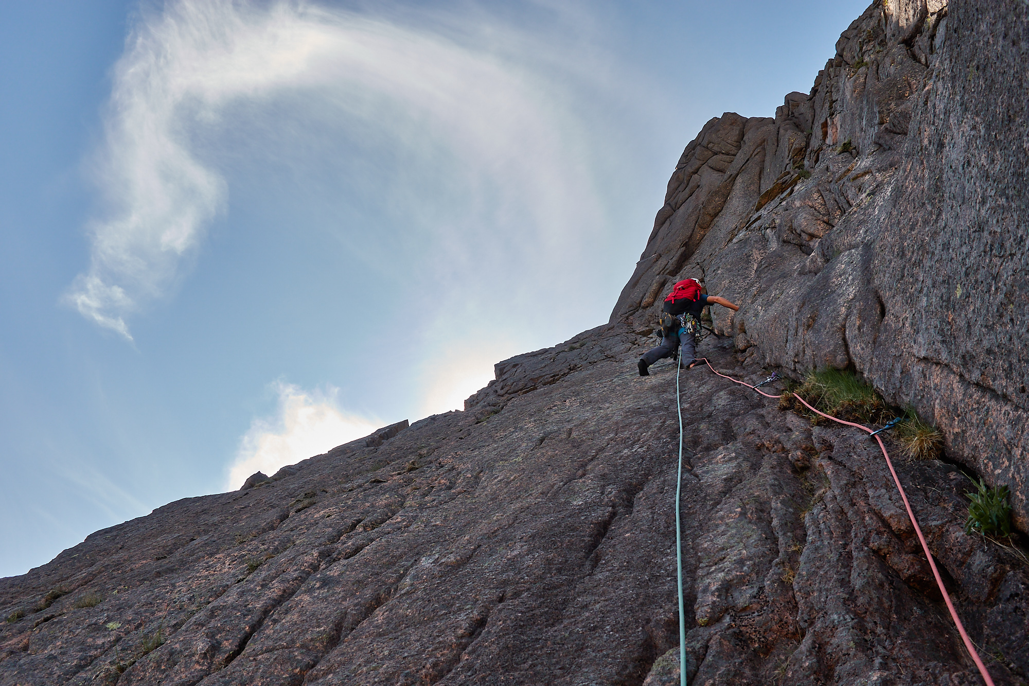 A climber on the Grey Slab pitch of the rock climb Grey Slab in Coire Sputan Dearg in the Cairngorms on a sunny day