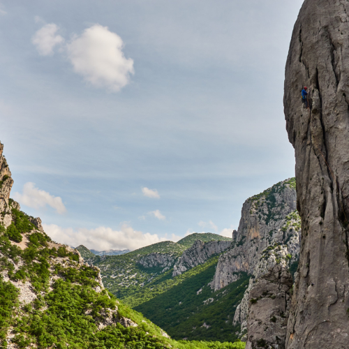 A climber at the end of the first pitch on a large limestone buttress called Stup on Anica Kuk in the Paklenica gorge in Croatia