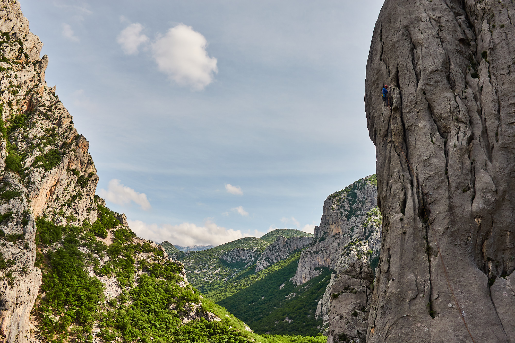 A climber at the end of the first pitch on a large limestone buttress called Stup on Anica Kuk in the Paklenica gorge in Croatia