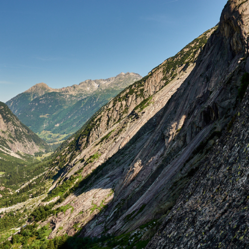 A view across the Handegg granite cliffs and slabs from a few pitches up Fairhands Line in the Grimsel Pass