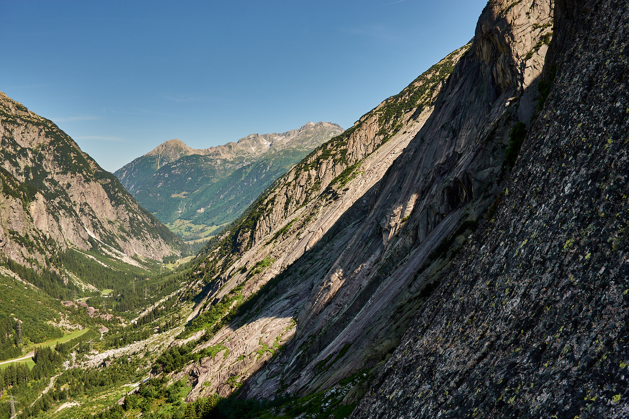 A view across the Handegg granite cliffs and slabs from a few pitches up Fairhands Line in the Grimsel Pass