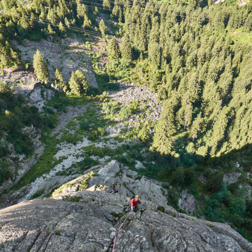 A view down the fourth pitch of a granite rock climb called Fairhands Line in the Grimsel Pass