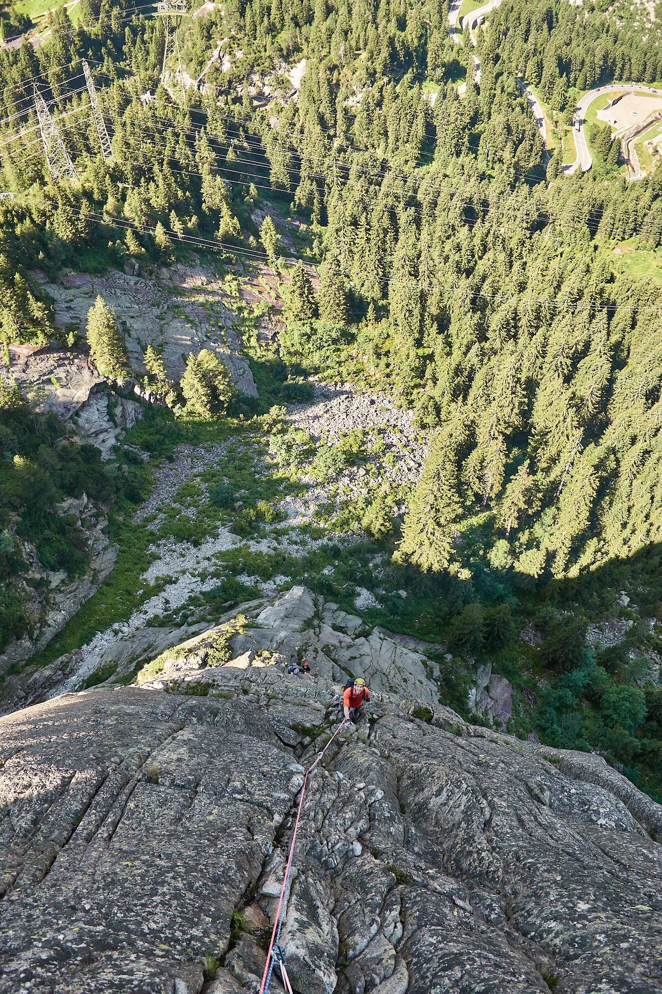 A view down the fourth pitch of a granite rock climb called Fairhands Line in the Grimsel Pass